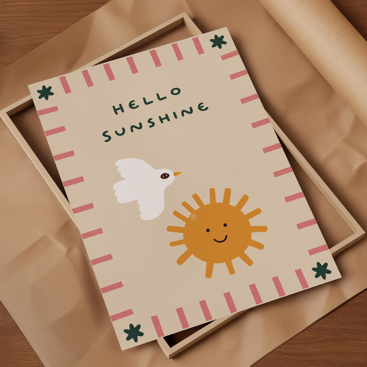 a greeting card with a cheerful design, including a white bird, a smiling sun, and a pink and green border.