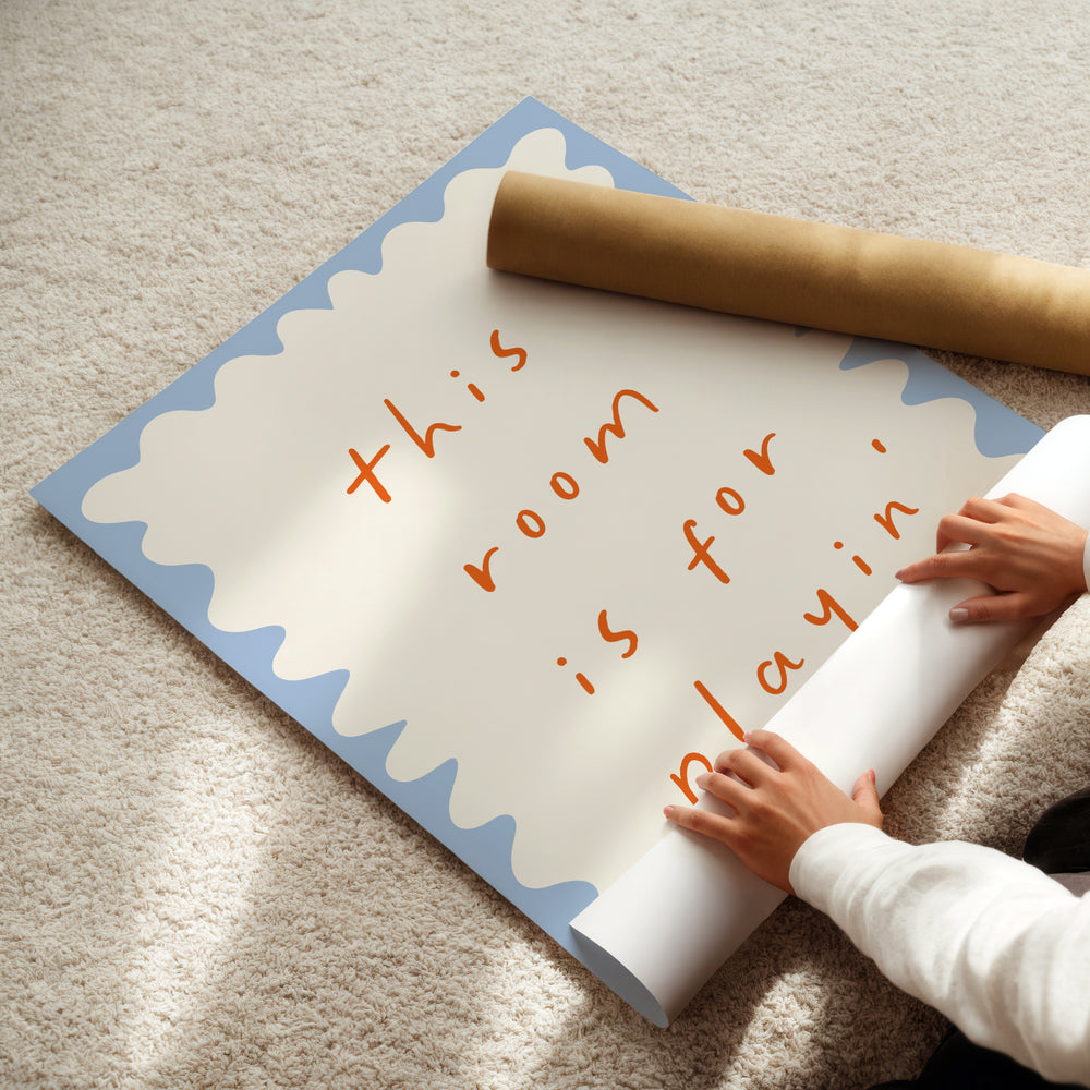 a child is holding a roll of paper on the floor
