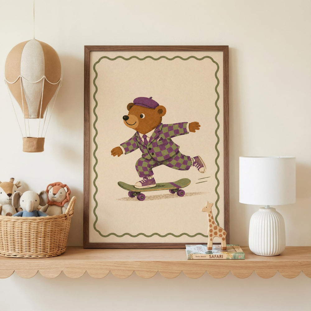 a framed illustration of a bear riding a skateboard, with a wicker basket of stuffed animals and a white lamp on a shelf below the frame.