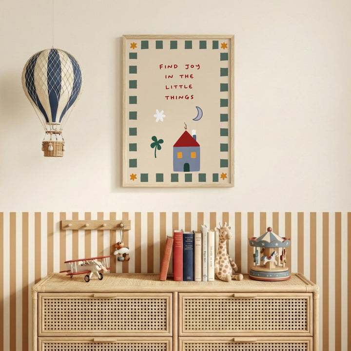 a children's bedroom with a wooden dresser, a toy airplane, a toy carousel, and a framed poster with a whimsical illustration and text.