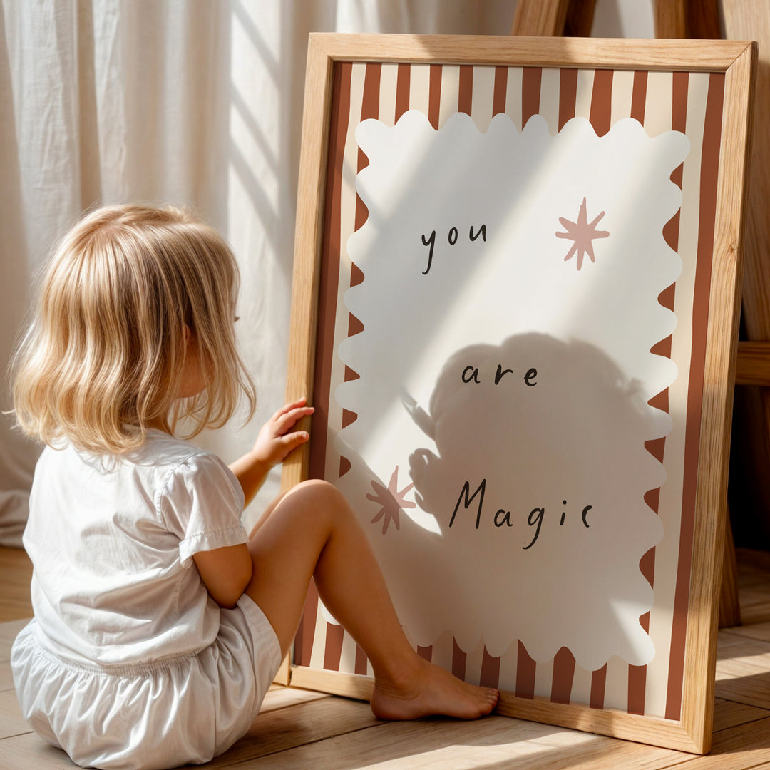 a little girl sitting on the floor next to a sign