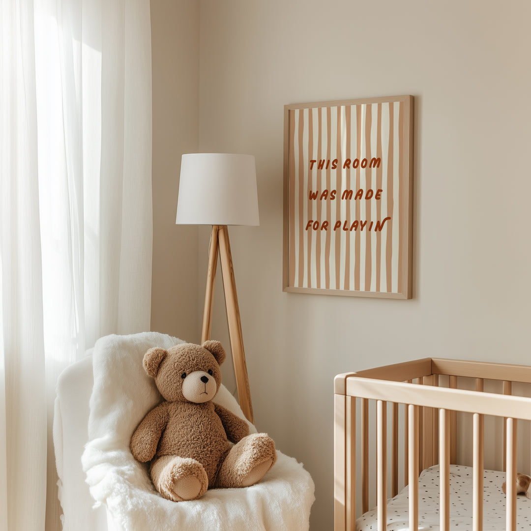 a teddy bear sitting in a chair next to a crib