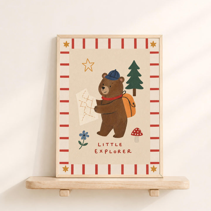 a bear holding a map and wearing a hat, with the text "Little Explorer" below the bear.
