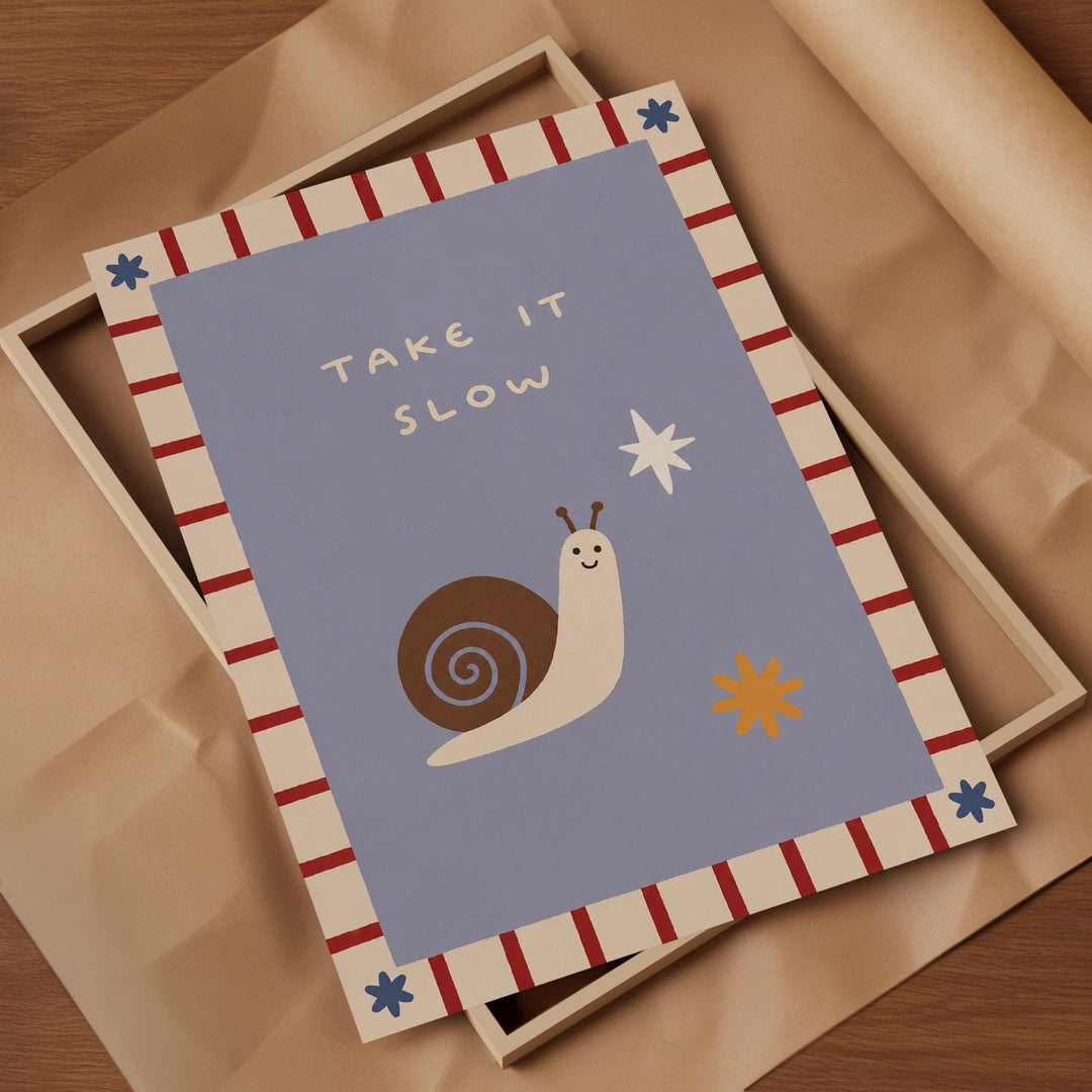 a framed card with a snail and a star on it, along with the text "Take it slow".