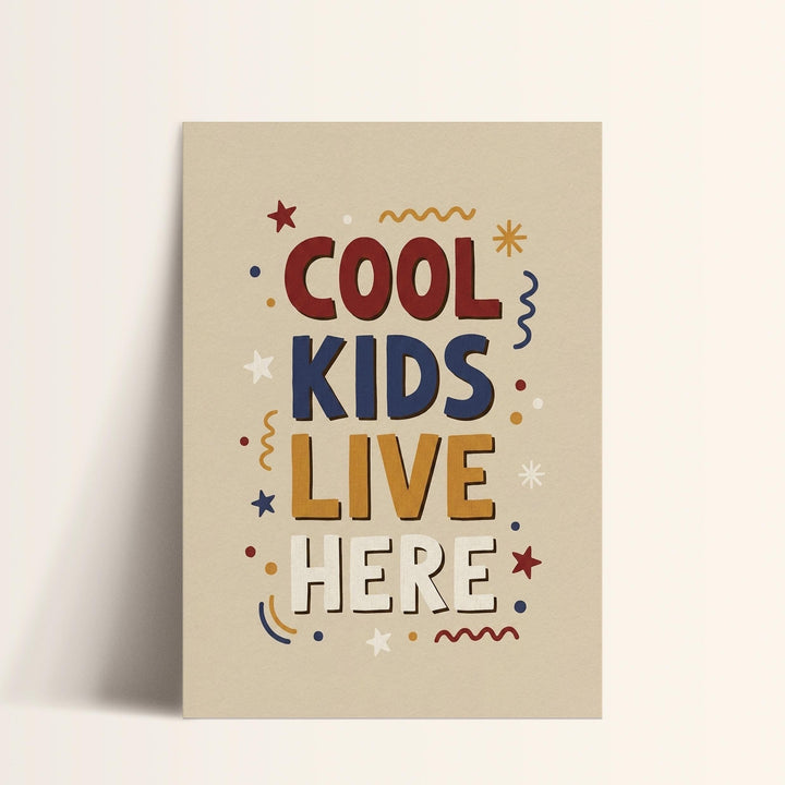 a poster with the text "COOL KIDS LIVE HERE" in a playful, colorful style.