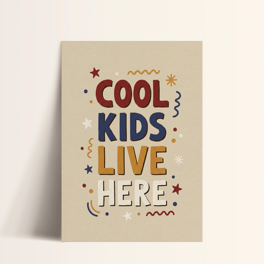 a poster with the text "COOL KIDS LIVE HERE" in a playful, colorful style.