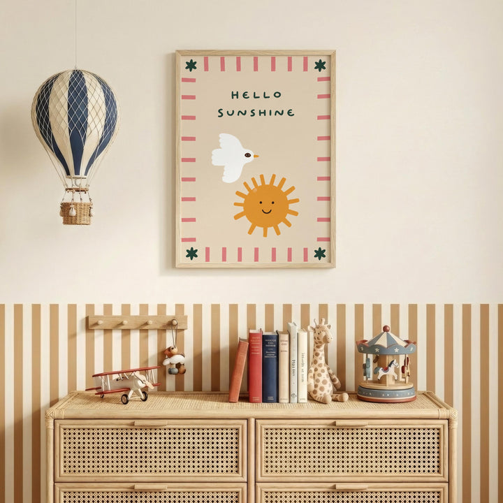 a children's bedroom with a wooden dresser, a toy airplane, a toy carousel, and a framed poster with a bird and a sun.