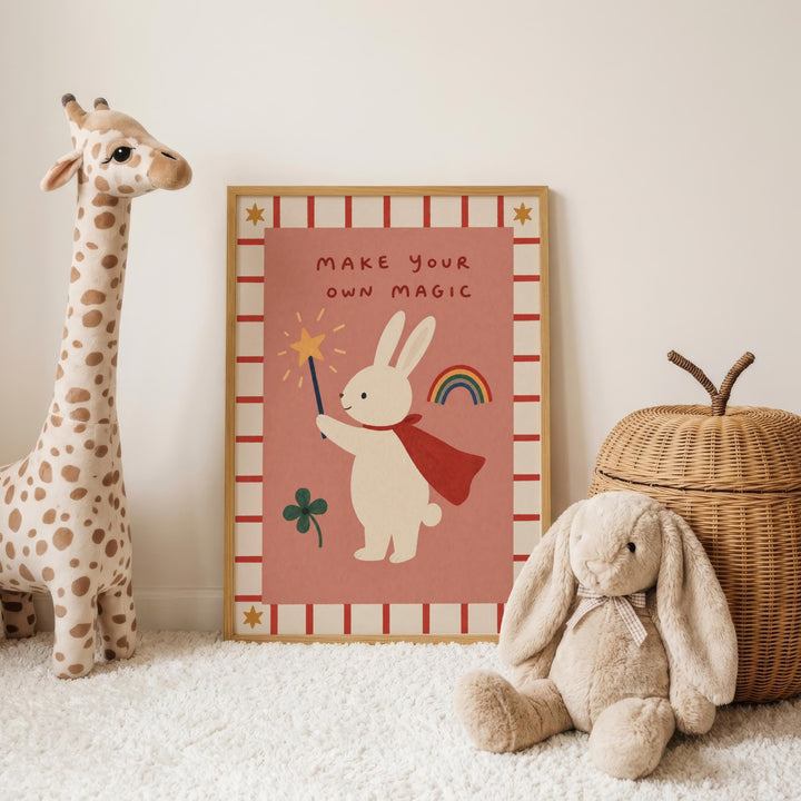 a poster with a cartoon rabbit holding a wand and a rainbow, accompanied by a stuffed giraffe and a stuffed rabbit on a white carpet.