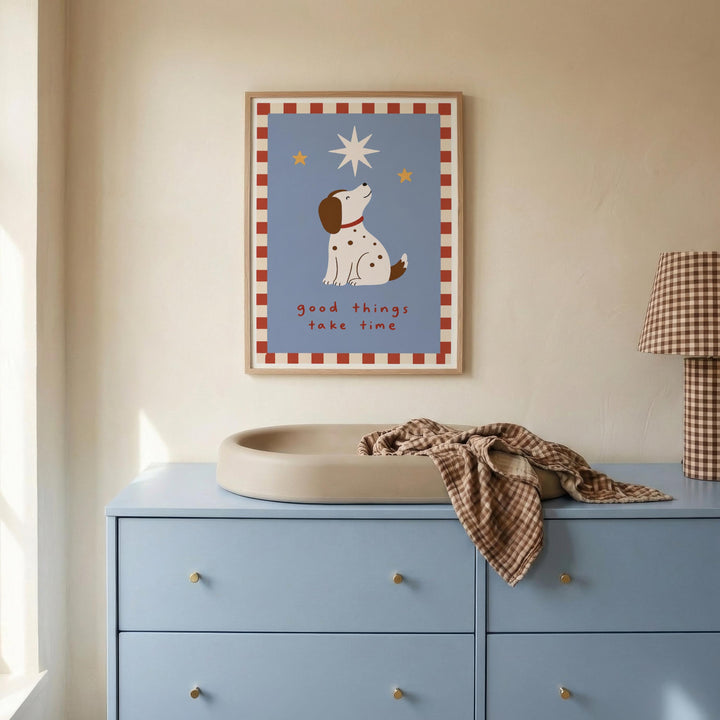 a blue dresser with a white sink, a framed poster of a dog looking up at the stars, and a plaid blanket on the dresser.