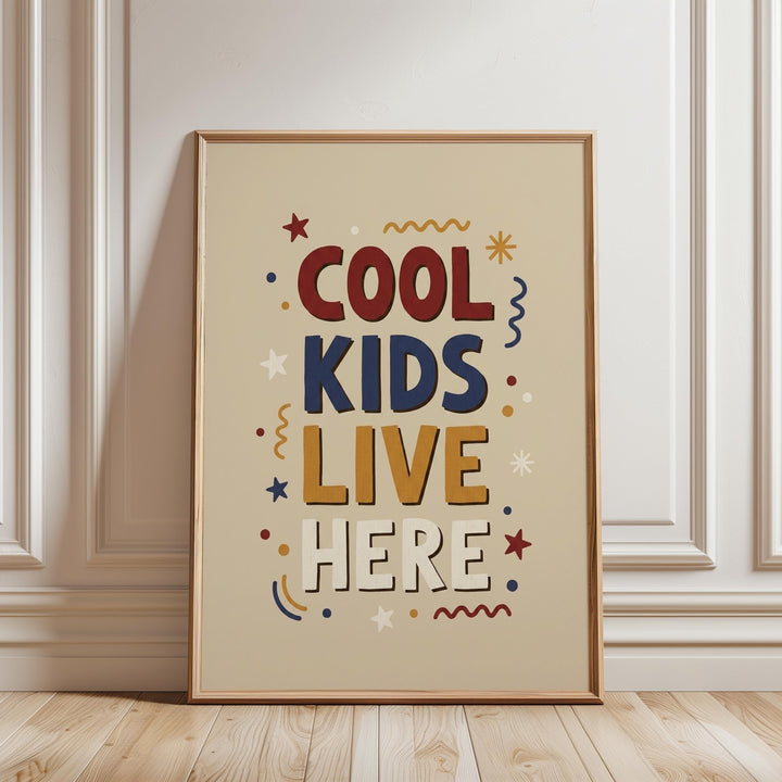 a framed poster with the text "COOL KIDS LIVE HERE" in a playful, colorful style.