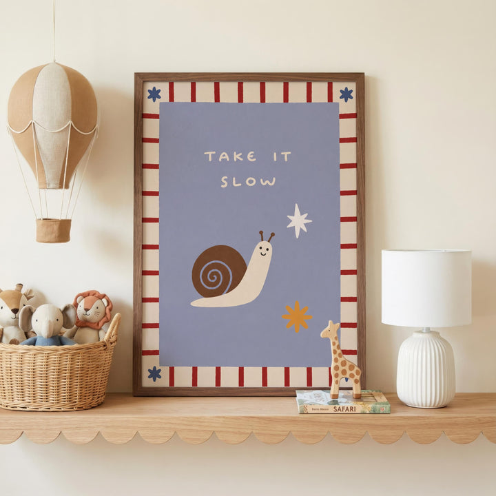 a children's bedroom with a framed poster on a shelf, a hot air balloon, a lamp, and a basket of stuffed animals.