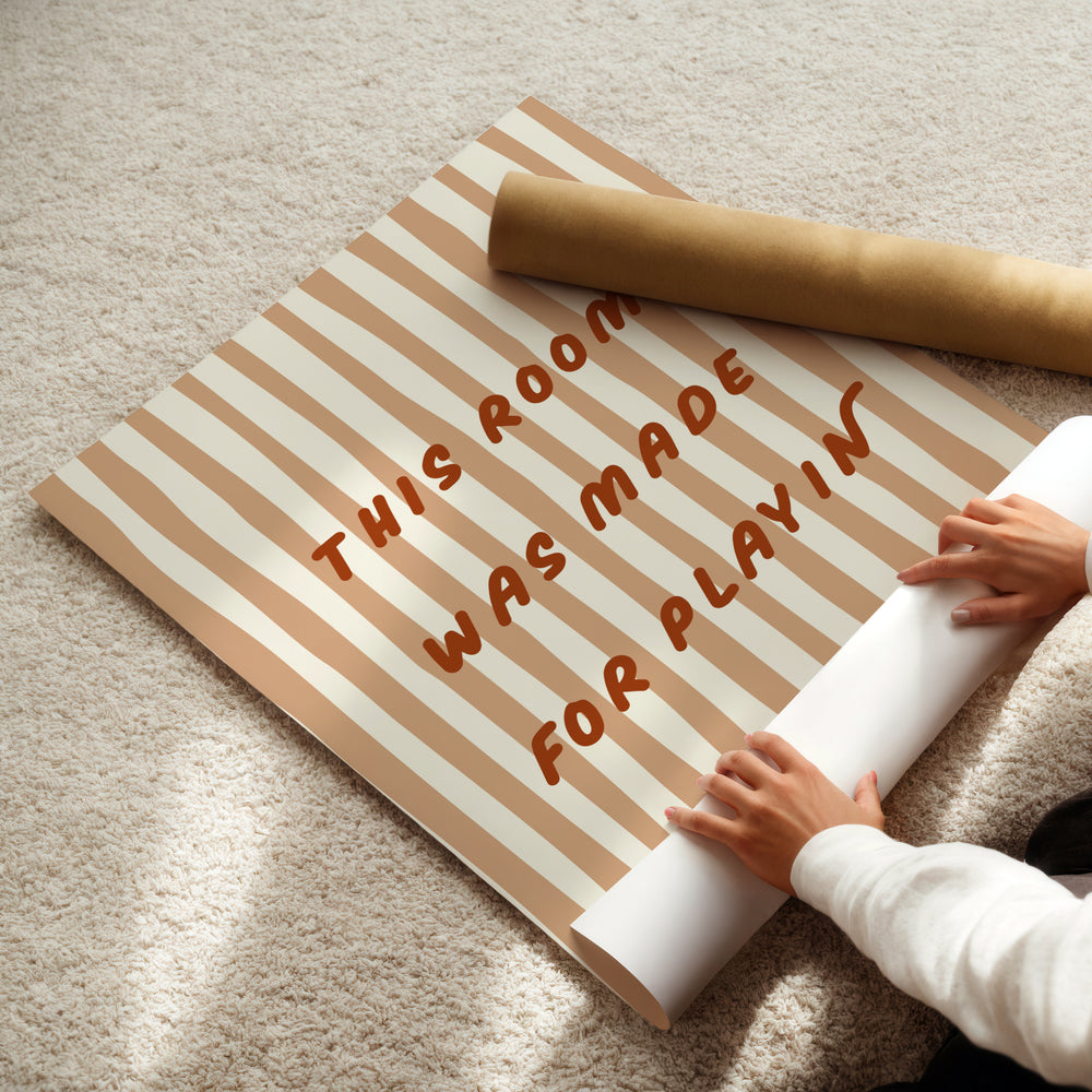 a person is laying on the floor with a roll of paper