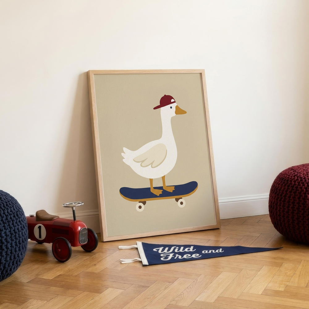 a framed illustration of a duck riding a skateboard, with a banner that reads "Wild Free and" placed on the floor next to the toy tractor.