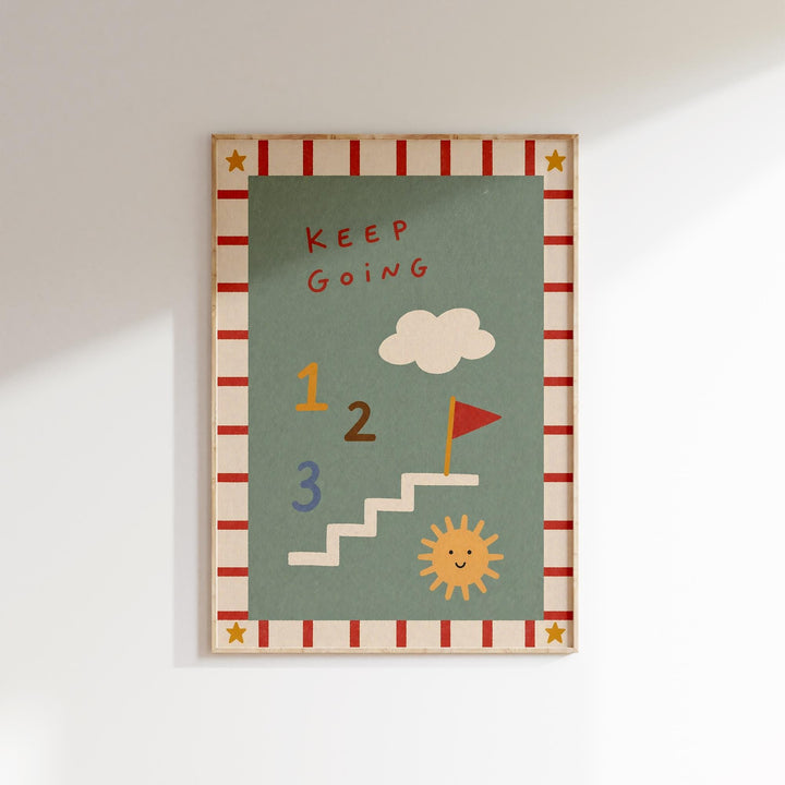 The image is a framed poster with a green background and various colorful illustrations, including a cloud, a flag, and a sun. The text "KEEP GOING" is written above the cloud, and the numbers "1", "2", and "3" are depicted below the cloud.