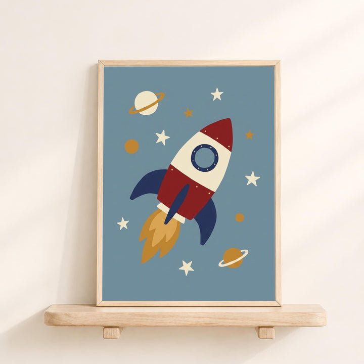 A framed illustration of a red, white, and blue rocket ship soaring through a space scene, with planets, stars, and a blue background.