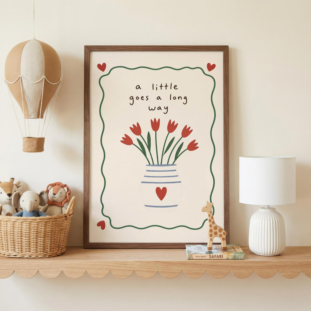 a framed picture with a vase of red flowers and a heart-shaped design, placed on a shelf next to a lamp and a basket of stuffed animals.