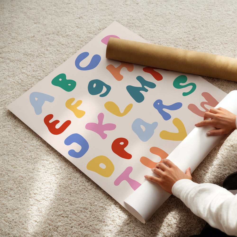 a child is playing with a large poster on the floor