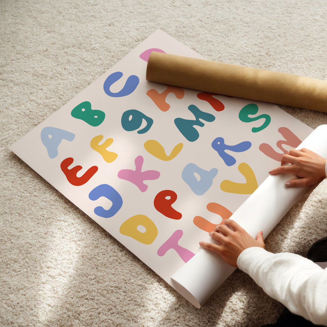 a child is playing with a large poster on the floor
