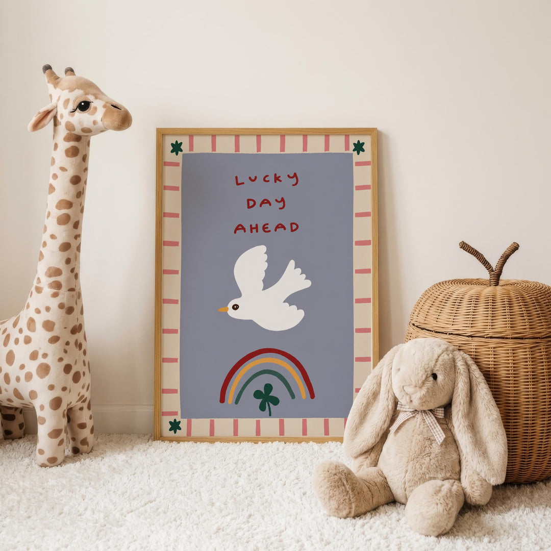 a giraffe, a stuffed rabbit, and a wicker basket, all placed on a white carpet. In the background, there is a framed poster with a bird and a rainbow, along with the text "Lucky Day Ahead".