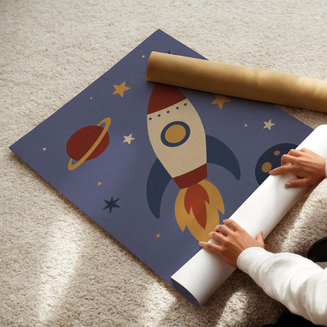 A child's hands are seen rolling up a blue poster featuring a rocket ship and space-themed illustrations.