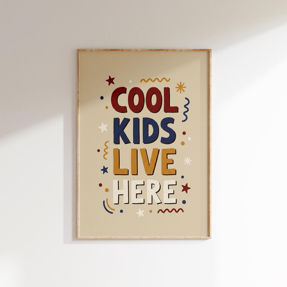 The image is a framed poster with the text "COOL KIDS LIVE HERE" in a playful, colorful style.