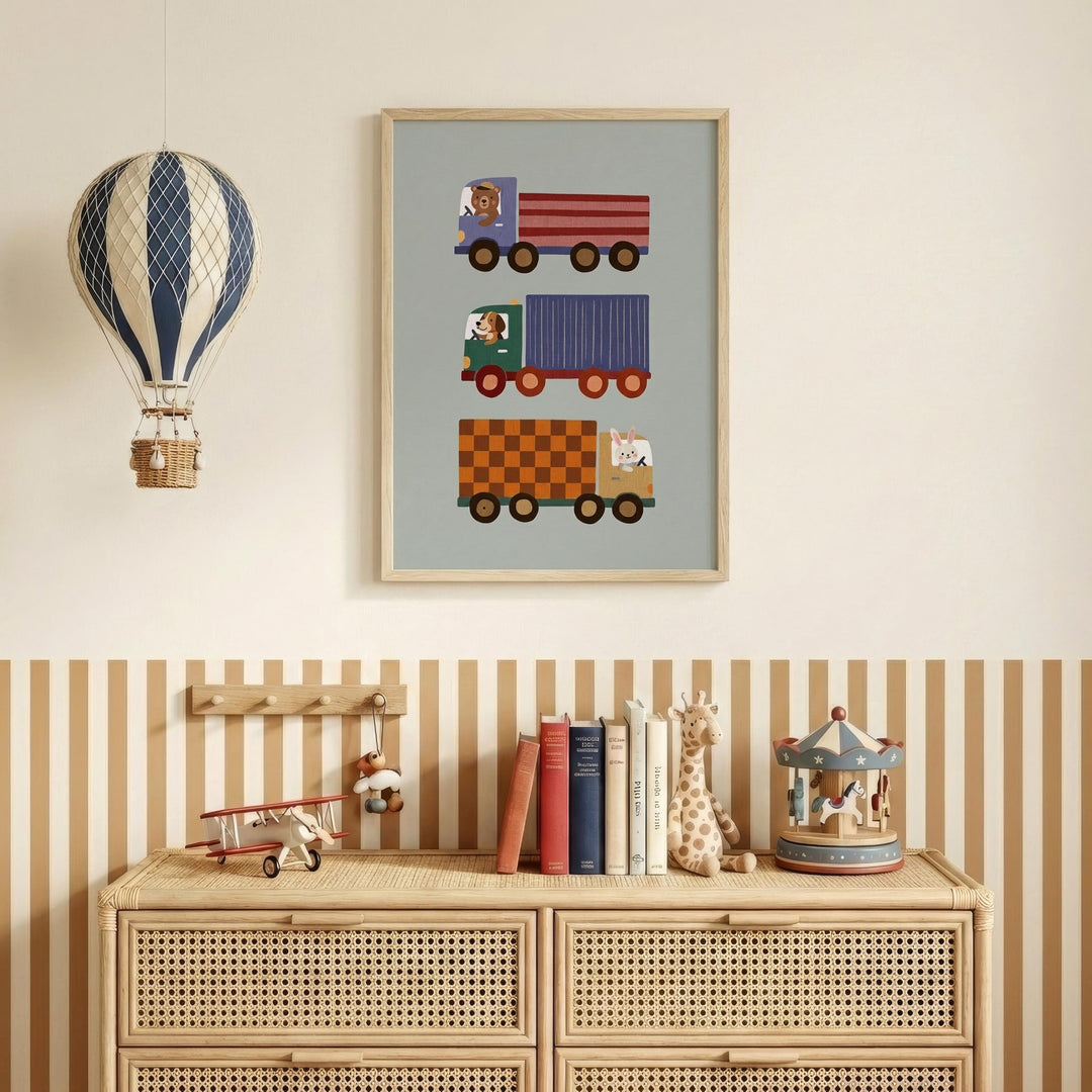 a wooden dresser with a framed poster of colorful toy trucks hanging above it, along with a hot air balloon and a carousel figurine on the dresser.