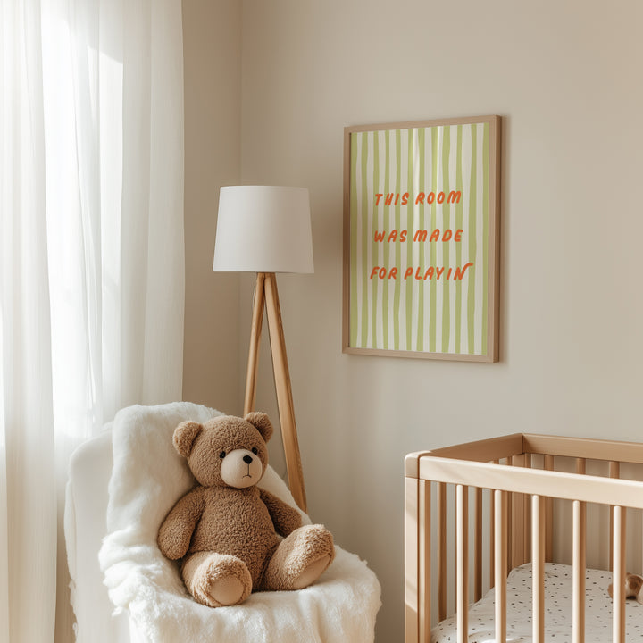 a teddy bear sitting in a chair next to a crib