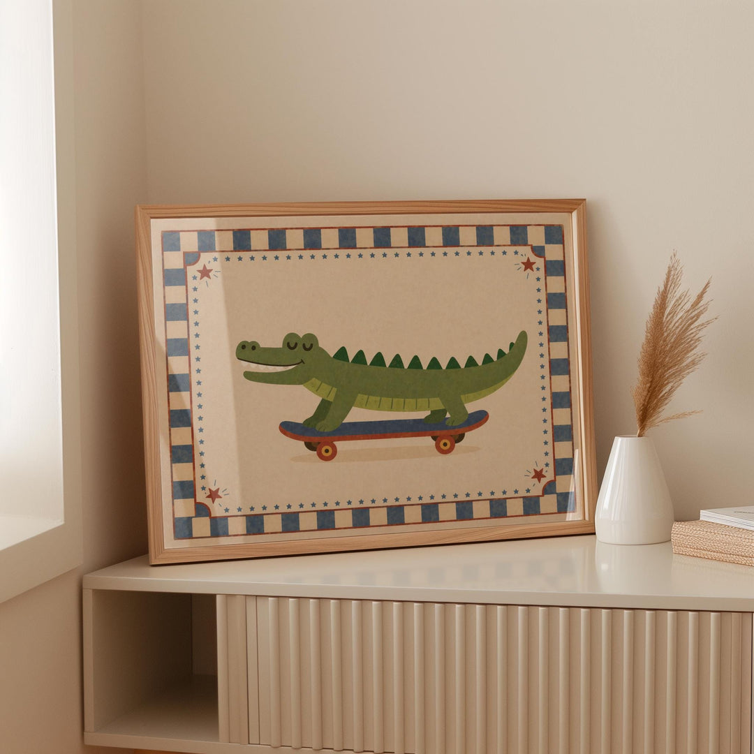 A framed illustration of a green alligator riding a skateboard is displayed on a shelf.