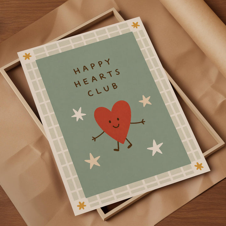 a card with a heart and stars, along with the text "Happy Hearts Club" written on it.