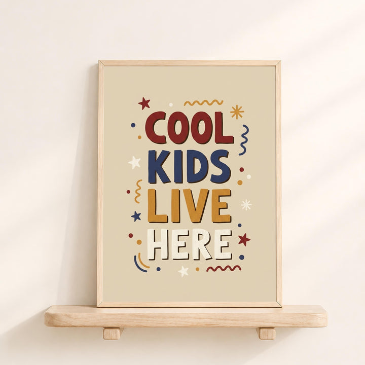 a framed poster with the text "COOL KIDS LIVE HERE" in a playful, colorful style.