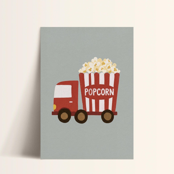 A red and white truck with a large red bucket labeled "POPCORN" is depicted in the image.