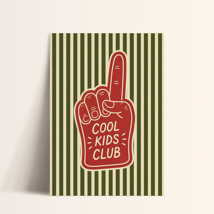 A red foam finger with the text "COOL KIDS CLUB" printed on it, against a striped green and white background.