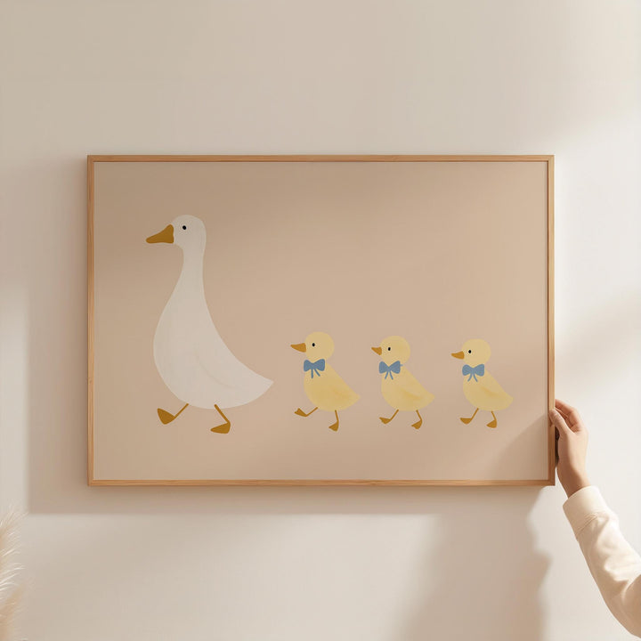 a person holding a picture of a duck and ducklings