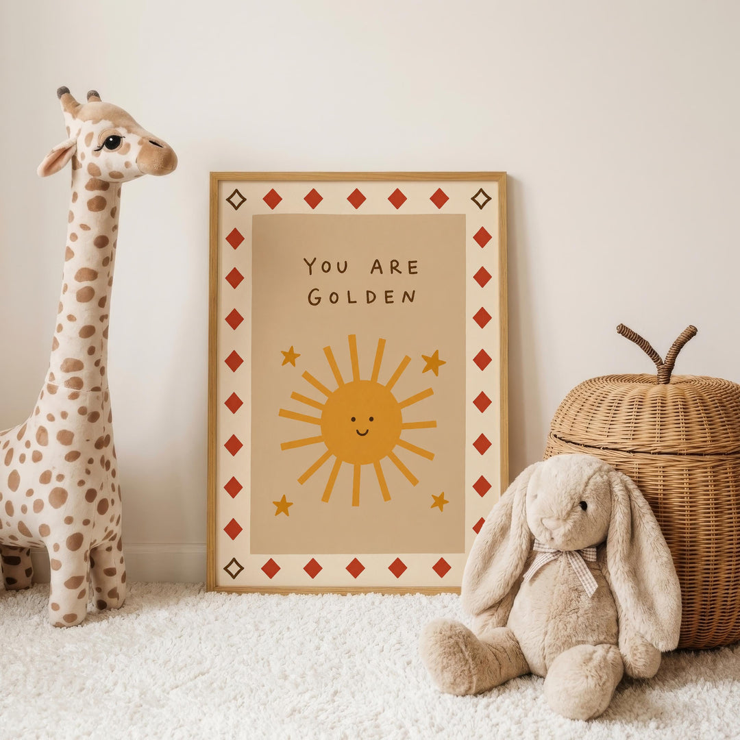 a giraffe, a stuffed rabbit, and a wicker basket, all placed on a white carpet. In the background, there is a framed poster with a sun and stars design, along with the text "You are Golden".