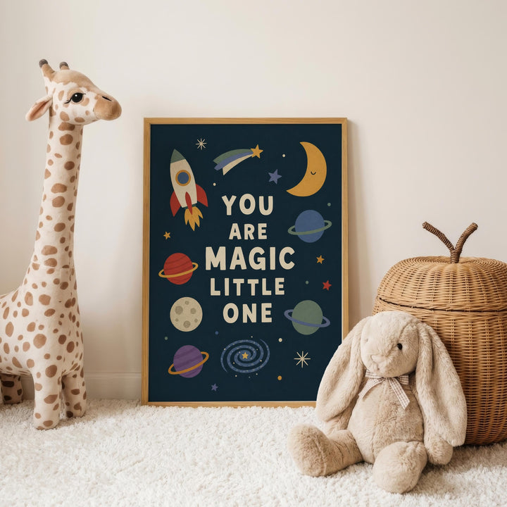 a giraffe and a stuffed rabbit, with a framed poster displaying the text "YOU ARE MAGIC LITTLE ONE" in the background.