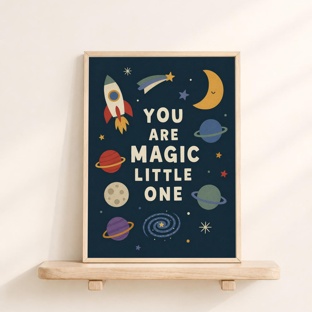 The image is a framed poster with a space-themed design, featuring a rocket ship, planets, and stars. The text on the poster reads "YOU ARE MAGIC LITTLE ONE".