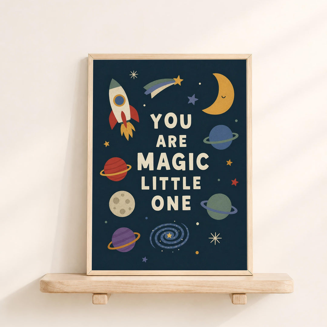 The image is a framed poster with a space-themed design, featuring a rocket ship, planets, and stars. The text on the poster reads "YOU ARE MAGIC LITTLE ONE".