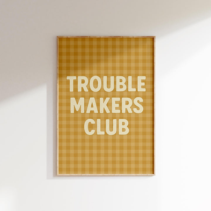 a picture hanging on a wall with the words trouble makers club