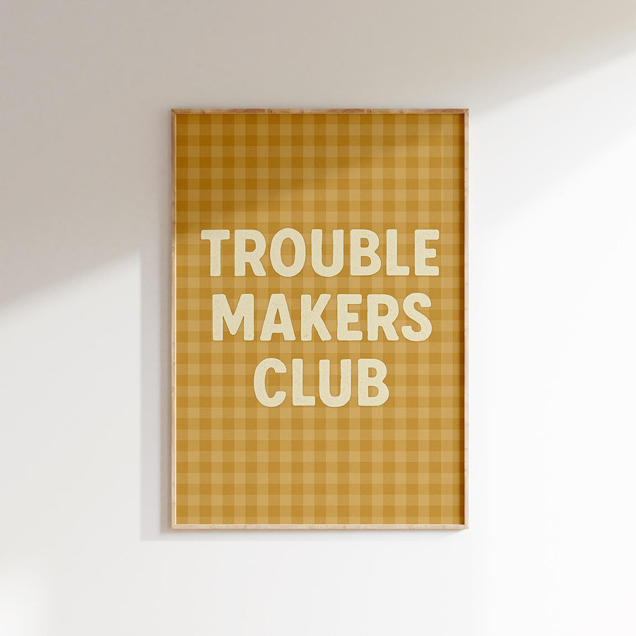 a picture hanging on a wall with the words trouble makers club