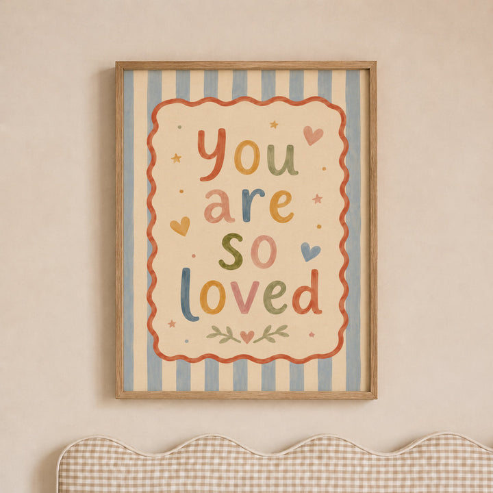 Illustrated nursery print reading 'you are so loved' in colourful folk lettering with hearts and stars