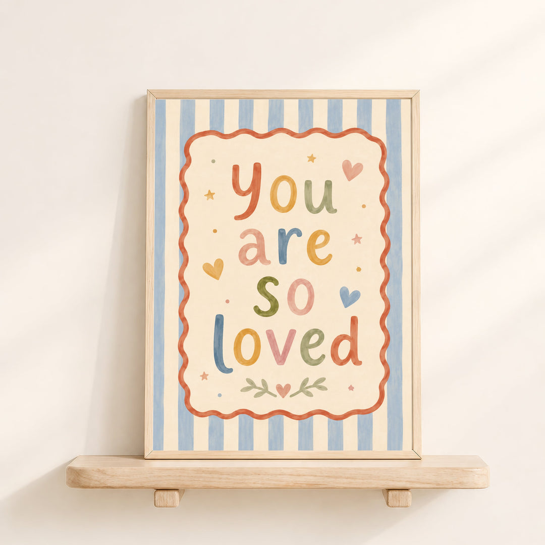 Illustrated nursery print reading 'you are so loved' in colourful folk lettering with hearts and stars