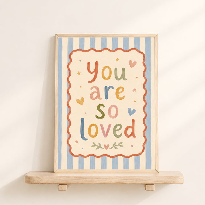 Illustrated nursery print reading 'you are so loved' in colourful folk lettering with hearts and stars