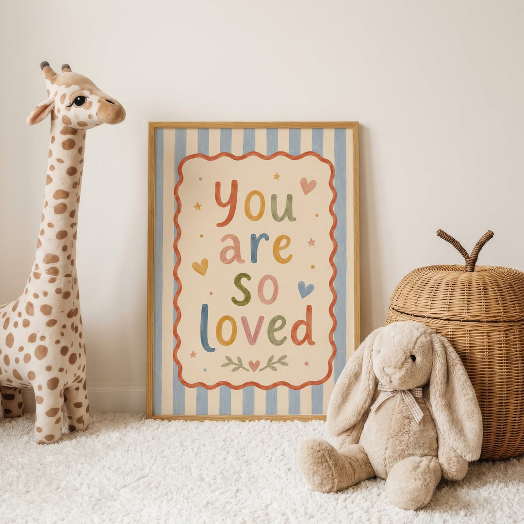 Illustrated nursery print reading 'you are so loved' in colourful folk lettering with hearts and stars