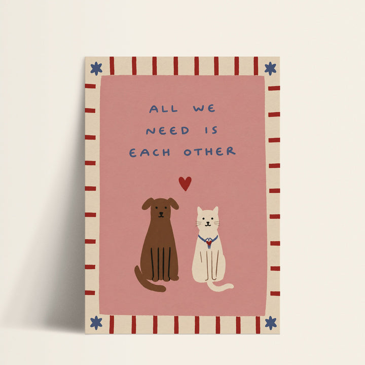 All We Need Is Each Other dog and cat print shown as a matte paper art print