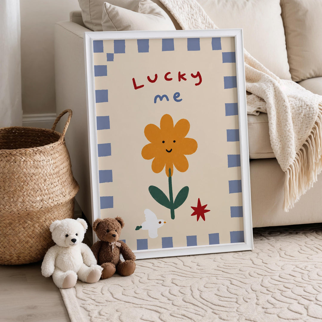 A framed poster with a cartoon flower and the words "Lucky me" is displayed on a beige rug, accompanied by two stuffed teddy bears.
