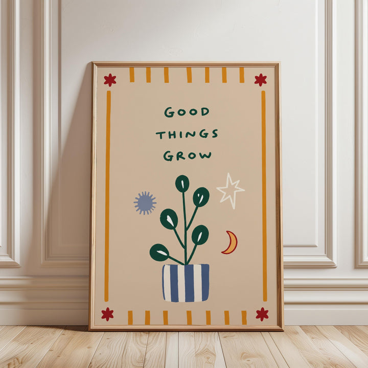 a framed poster with a plant and various decorative elements, including a star, moon, and sun, along with the text "Good things grow".