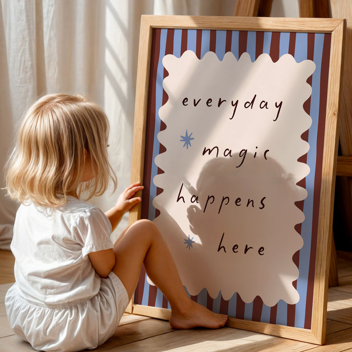 a little girl sitting on the floor next to a sign
