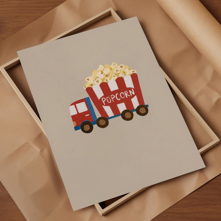 A framed print with a cartoon image of a red and white popcorn truck.