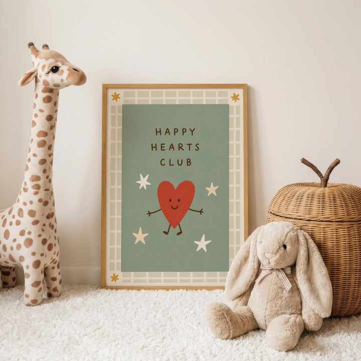 a giraffe, a stuffed rabbit, and a wicker basket, all arranged on a white carpet. In the background, there is a framed poster with a heart and stars design, and the text "HAPPY HEARTS CLUB" written on it.