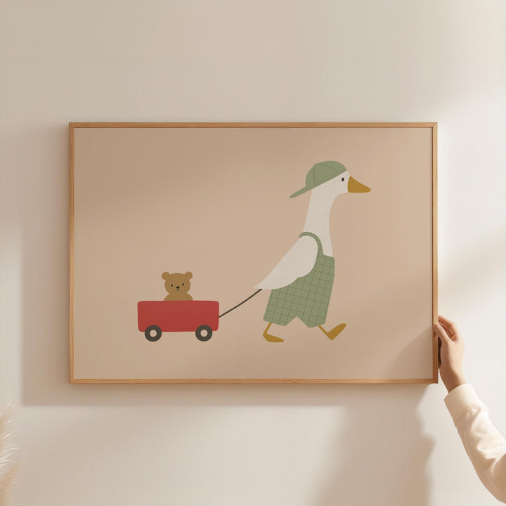 a person holding a picture of a duck and a teddy bear